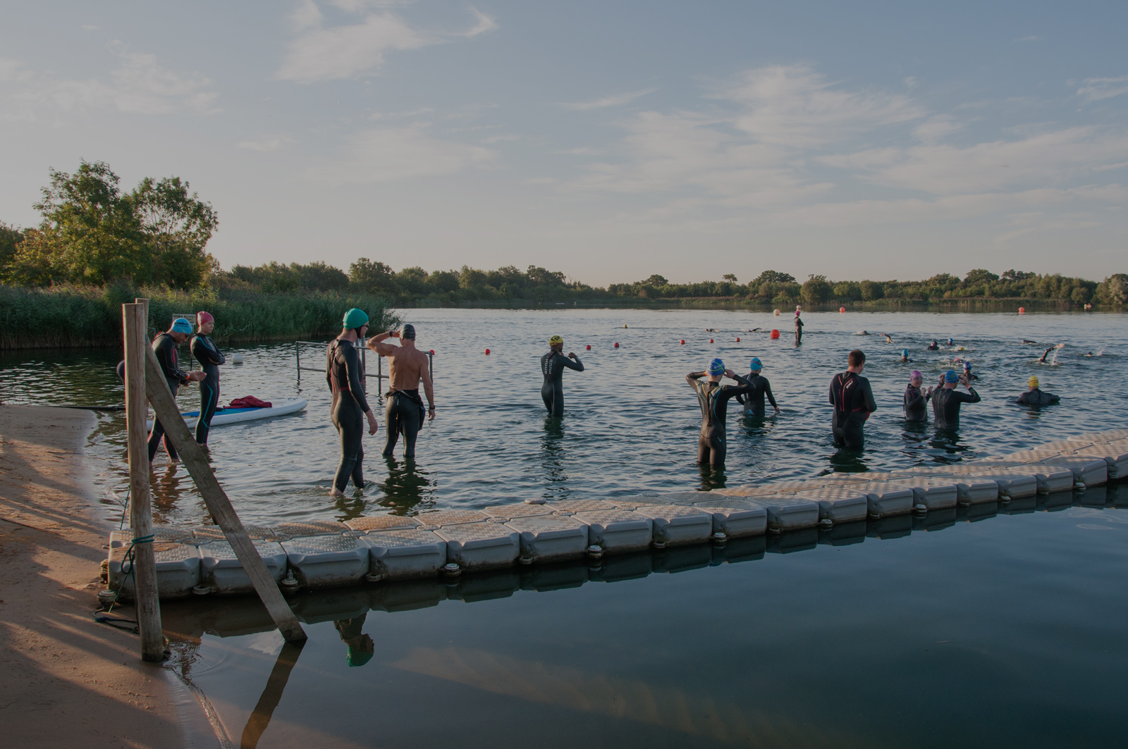 Swim for Tri open water swimmers entering the water at Stubbers Lake, Essex