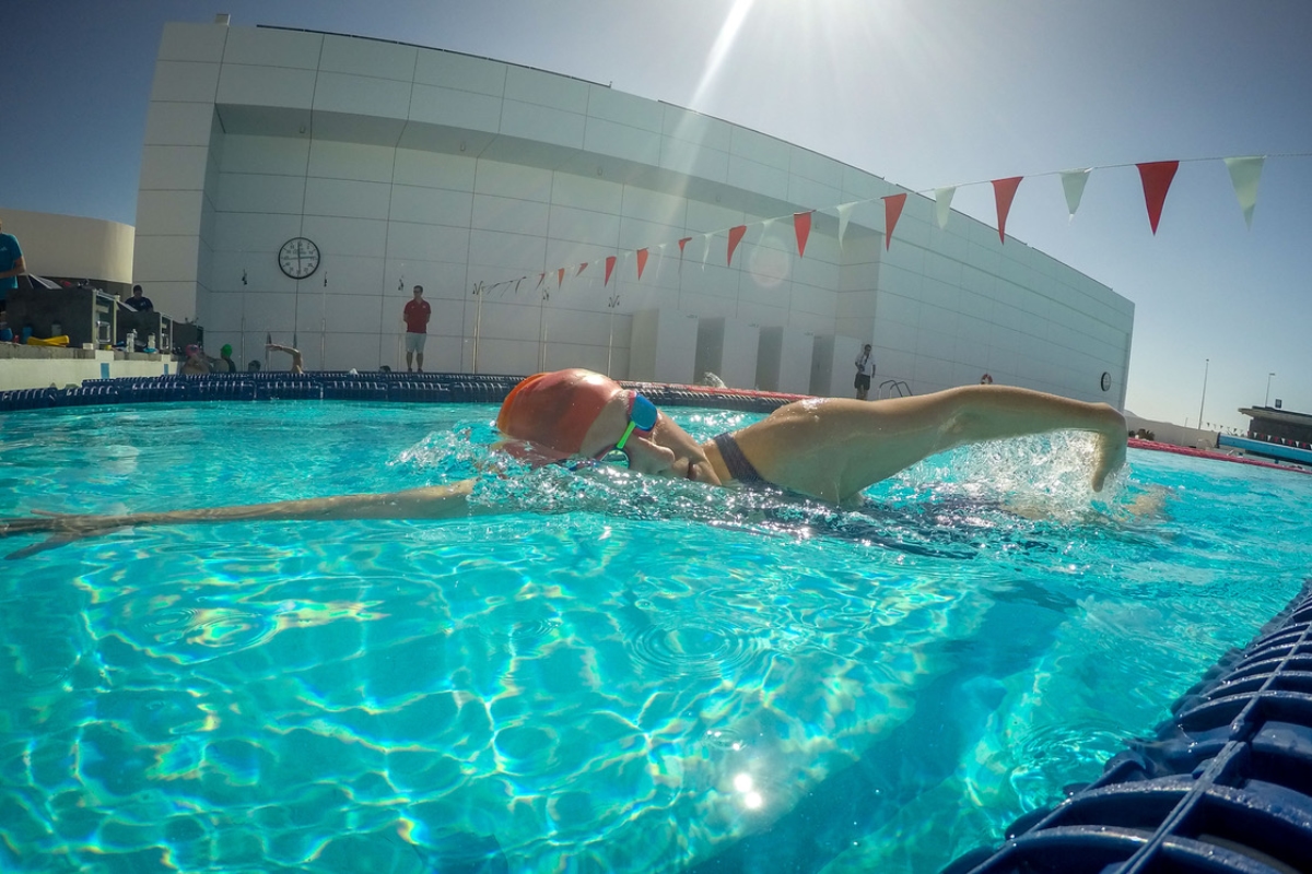 Swimming front crawl in open air pool