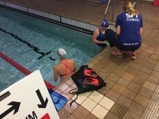 Swim for Tri coach providing instruction from the poll side.