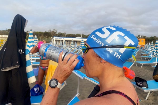 Swim for Tri - Person swimming front crawl in open air swimming pool